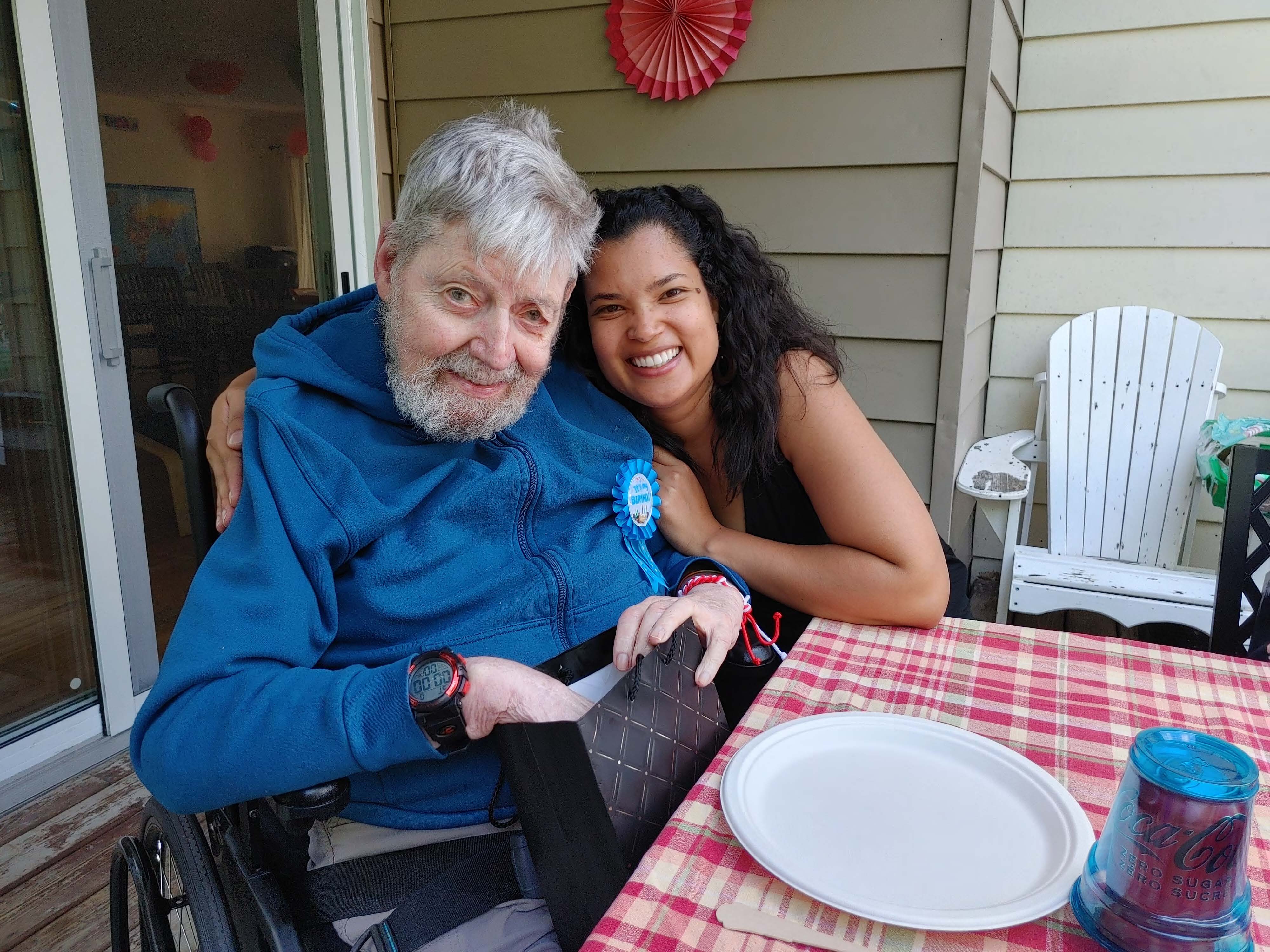 une assistante posent avec un membre de cœur qui ouvert un cadeau